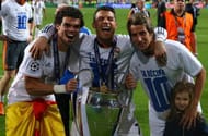 Cristiano poses with the trophy alongside Pepe and Marcelo