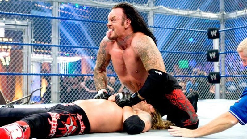 Undertaker delivering a Tombstone piledrive to Edge.