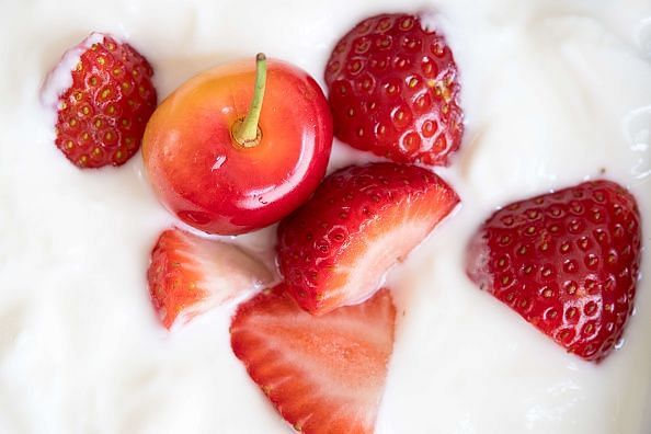 Healthy eating: white plain yogurt with strawberries pieces...