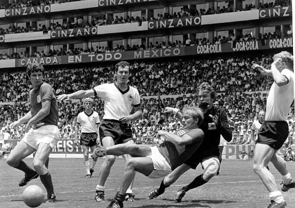 Volume 2. Page: 34. Picture 5. Football. 1970 World Cup Quarter Final. Leon, Mexico. 15th June, 1970. West Germany 3 v England 2. England+s Brian Labone (left) and Francis Lee (centre) challenge West Germany+s Klaus Fitschel, Franz Beckenbauer, goalkeeper