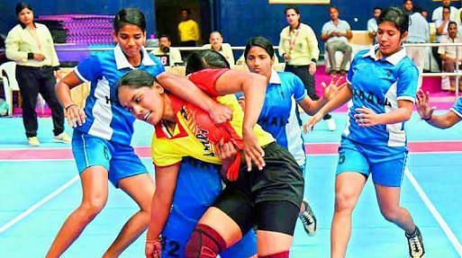 Kerala women players trap Andhra raider (centre) in their pre-quarterfinal of 65th