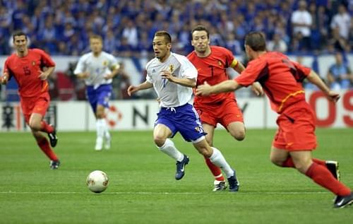 BT Football. 2002 FIFA World Cup Finals. Saitama, Japan. 4th June 2002. Japan 2 v Belgium 2. Japan's Hidetoshi Nakata passes the challenge of Belgium's Marc Wilmots.