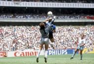1986 World Cup Quarter Final, Azteca Stadium, Mexico, 22nd June, 1986, Argentina 2 v England 1, Argentina's Diego Maradona scores his side's first goal past English goalkeeper Peter Shilton by use of his hand, Maradona later claimed that the goal was scor