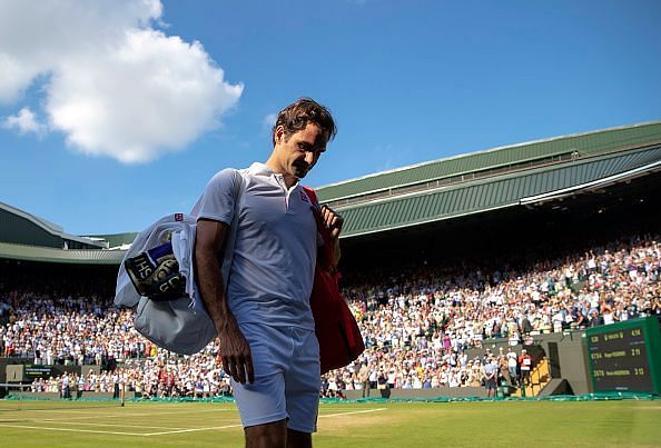 Roger Federer makes his way out of the 2018 Wimbledon Championships after losing to Kevin Anderson