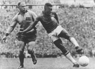 1958 World Cup Final. Stockholm, Sweden. 29th June, 1958. Sweden 2 v Brazil 5. Brazil's Pele shoots as he is challenged by a Swedish defender.