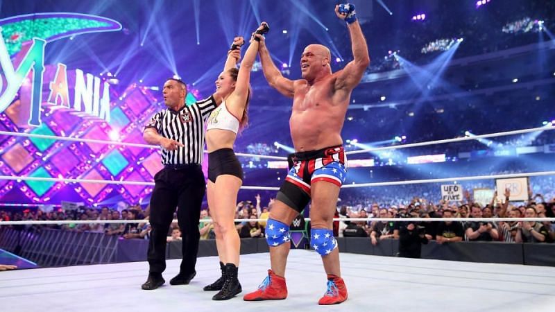 Kurt Angle and Ronda Rousey celebrate after their win at WrestleMania 34