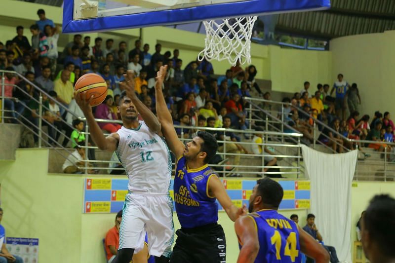 Clinton Andrew of Vijaya Bank with a contested layup