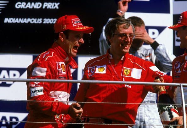 Race winner Ferrari driver Rubens Barrichello of Brazil, Ferrari engine director Paolo Martinelli, and second placed Ferrari driver Michael Schumacher of Germany celebrate a 1-2 finish