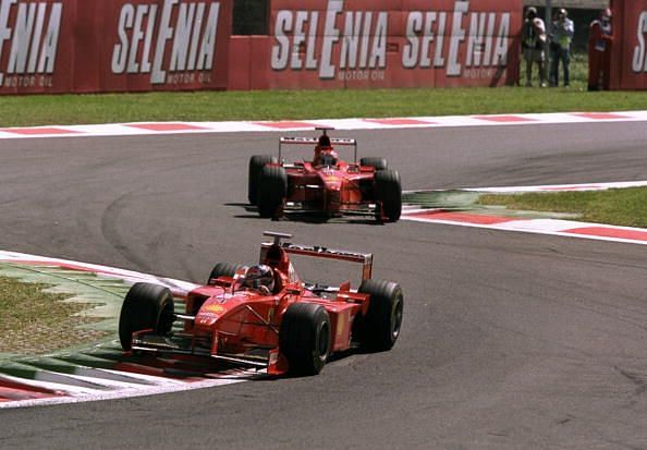 Michael Schumacher of Germany leads team-mate Eddie Irvine of Great Britain