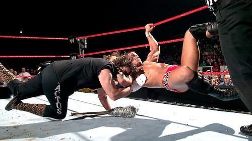 Randy Orton RKOs Cactus Jack on a barbed wire bat