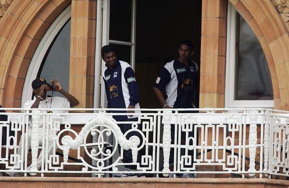 Sri Lankan spin bowler Muttiah Muralitharan watches from the pavilion