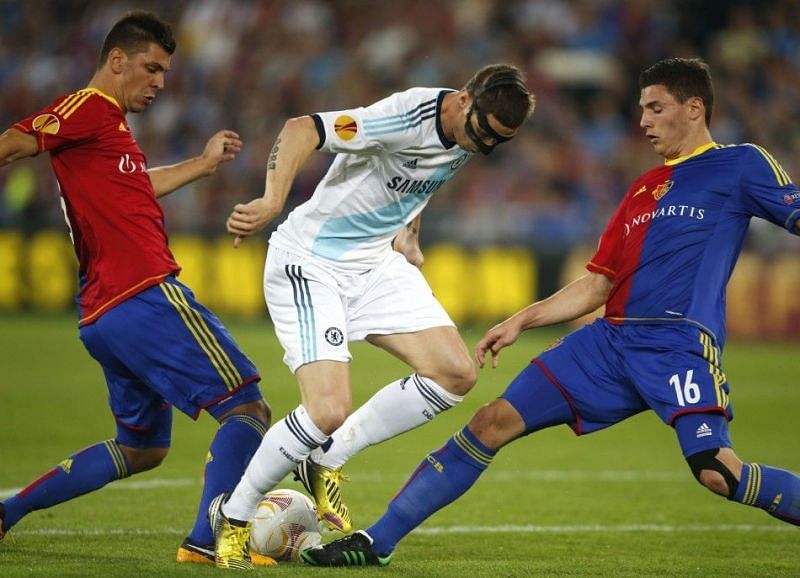 Dragovic (L) and Schar (R) defending against Fernando Torres of Chelsea in 2013