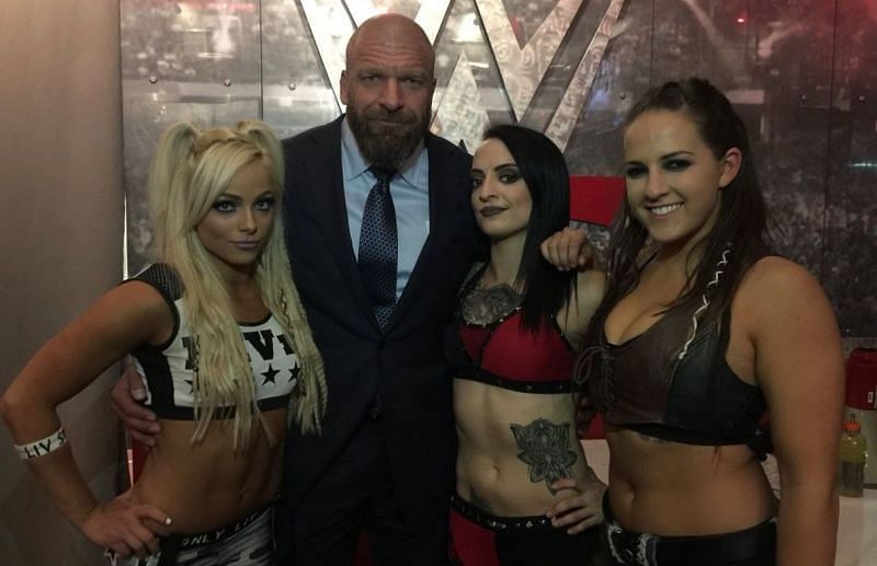 Ruby Riott with the Riott Squad, and Triple H
