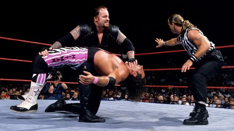 Undertaker put pressure on Bret Hart while Shawn Michaels looked on