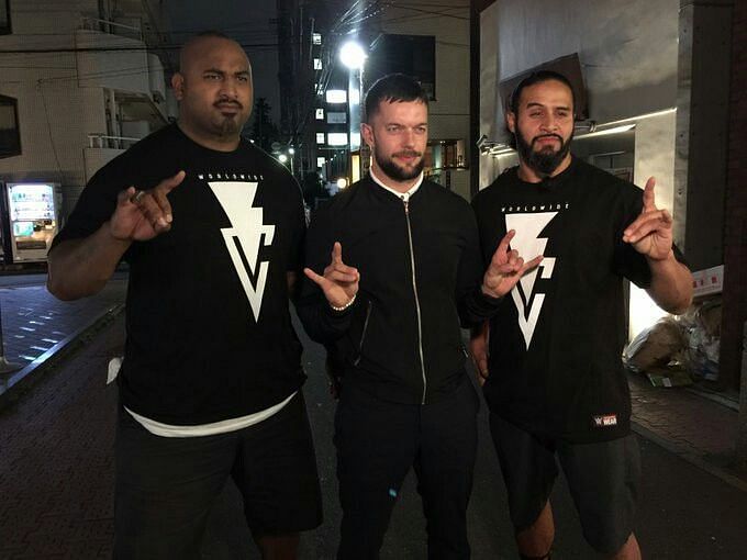 Finn Balor with Bad Luck Fale (left) and Tama Tonga (right) 