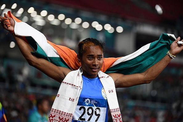 India&#039;s Hima Das celebrates winning the silver medal after the final of the women&#039;s 400m athletics event during the 2018 Asian Games in Jakarta