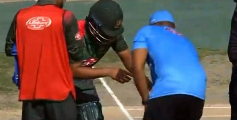 Tamim is treated by the physio after injuring his wrist