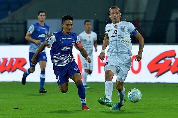 Mumbai City captain Lucian Goian (R) fighting for the ball against Sunil Chhetri (L). 