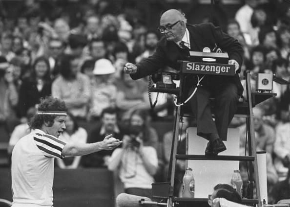John McEnroe arguing with the chair umpire in a Wimbledon match.