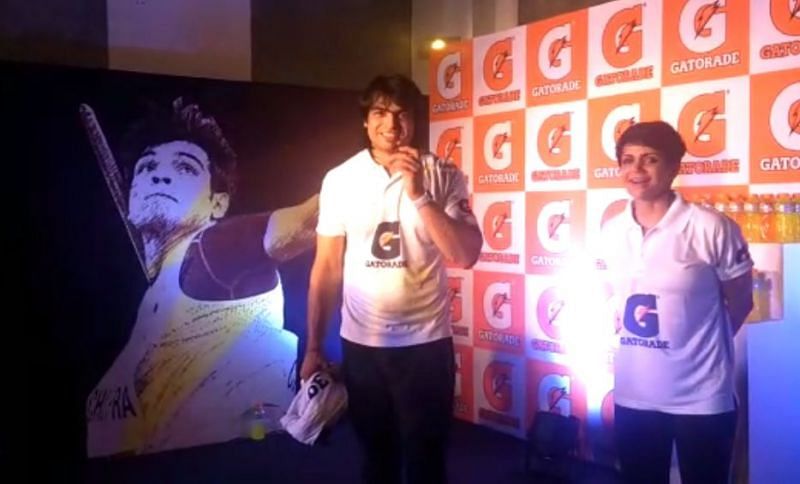 Neeraj Chopra and Mandira Bedi share a light moment on stage at the Welcome event