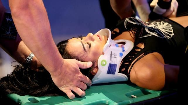 WWE Diva AJ Lee being carried off in a stretcher