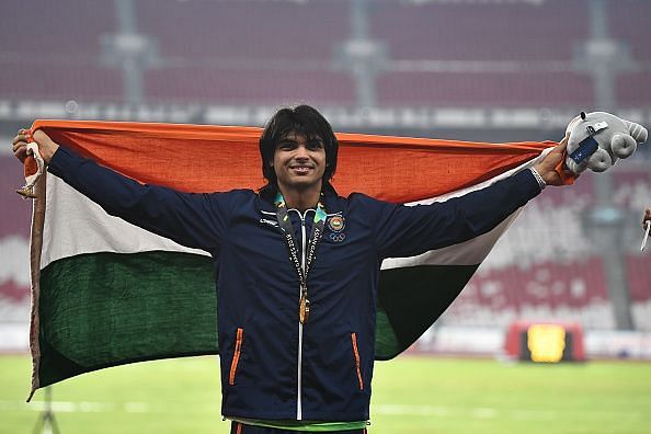 Neeraj Chopra celebrates his Asiad gold medal on the podium