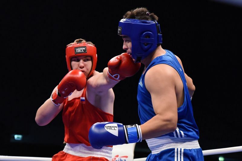 Dronov of Russia in Red with a big Left hand against Damir Toibay of Kazakhstan (Image Courtesy: AIBA)