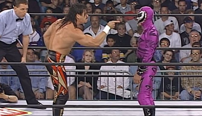 Eddie Guerrero faces off with Rey Misterio, who is dressed as the comic character The Phantom