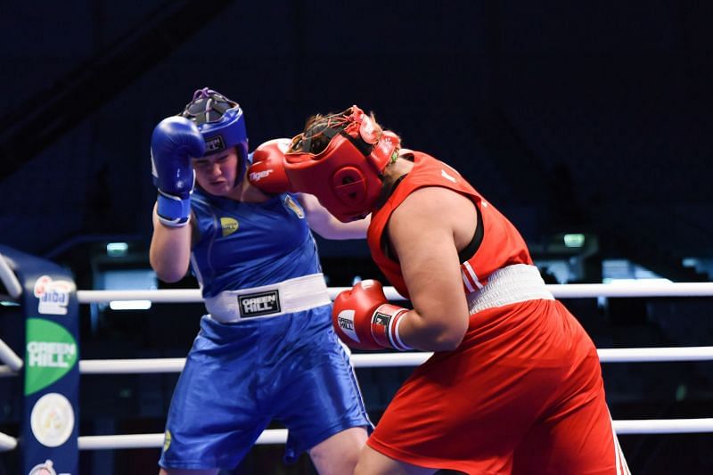 Islambekova of Kazakhstan in Red produces a big Right Hook against Lovchynska of Ukraine (Image Courtesy: AIBA)