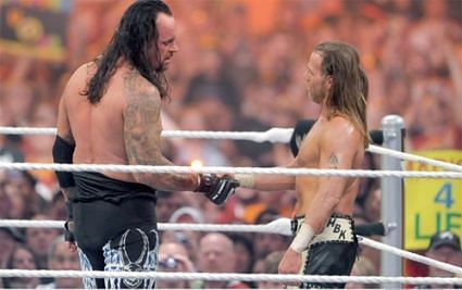 Michaels and the Undertaker shake hands after their 2nd Wrestlemania classic in a row