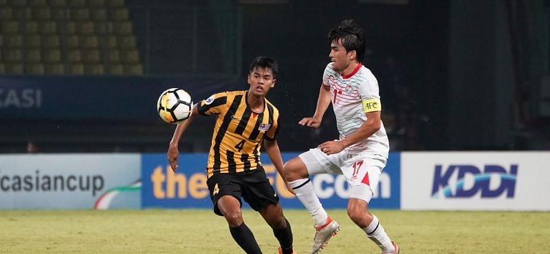 Tajikistan goalscorer Ehson Panshanbe in action against Zahril Zabri of Malaysia (Image Courtesy: AFC)