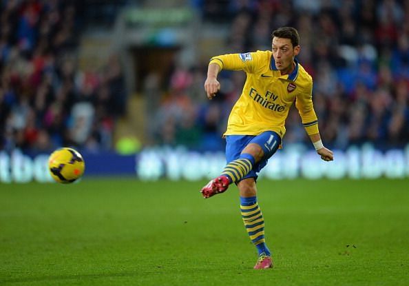 Mesut Ozil threads a pass in a premier game against Cardiff City