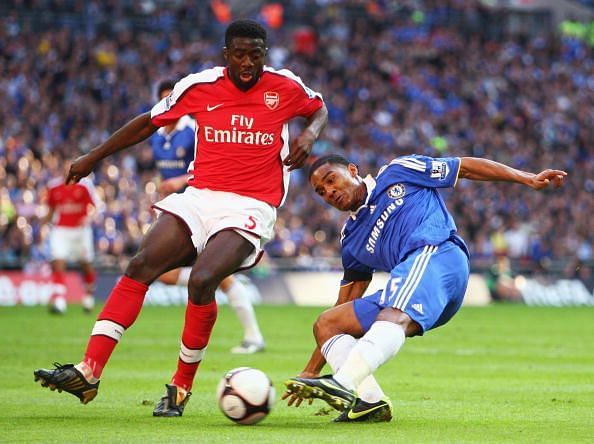 Florent Malouda of Chelsea is closed down by Kolo Toure of Arsenal