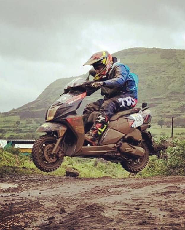 Syed Asif Ali riding the scooter at a motorsport event