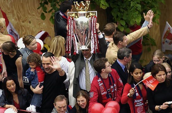 Arsenal manager Arsene Wenger lifting the FA Barclaycard Premiership trophy