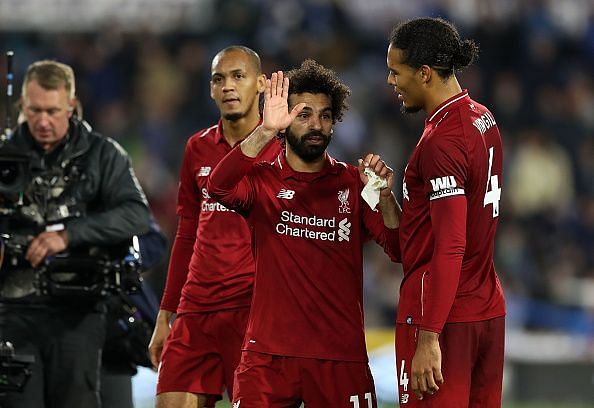 Relief: Salah celebrates post-match with van Dijk and Fabinho, the latter making his Premier League debut