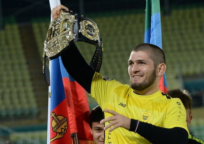 Khabib hoisting his belt up high for the crowds to see at the Anzhi Arena