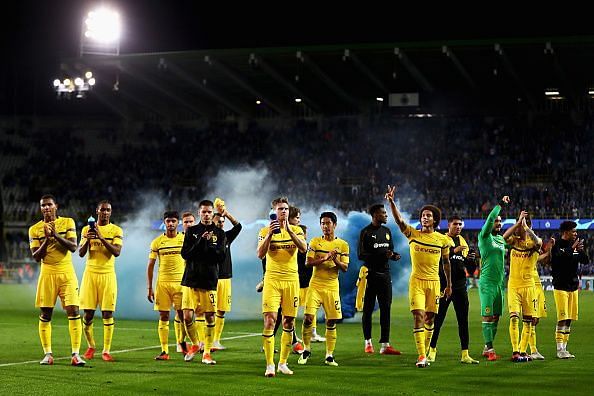 Dortmund players celebrate with the away fans after their win over Club Brugge