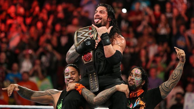 Reigns celebrates his World Title win with The Usos