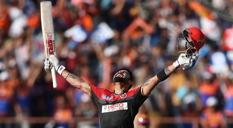 Virat Kohli celebrates after reaching the three-digit landmark for the first time in his IPL career