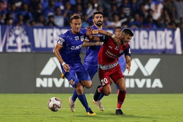 Lucian Goian of Mumbai City FC (left) vies for the ball and Sergio Cidoncha of Jamshedpur FC (right)