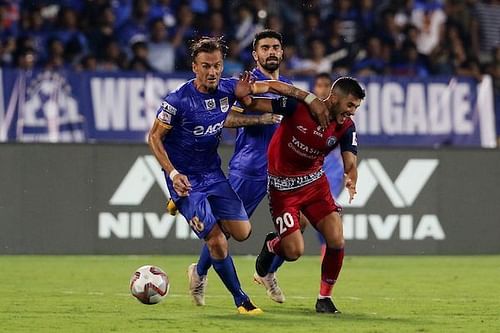 Lucian Goian of Mumbai City FC (left) vies for the ball and Sergio Cidoncha of Jamshedpur FC (right)