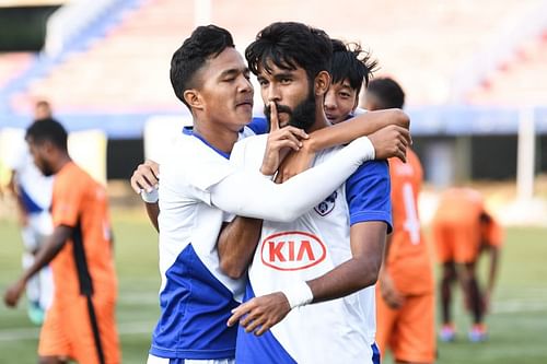 Myron Mendes is congratulated by his teammates after scoring Bengaluru FC's third goal against South United FC during their Puttaiah Memorial Cup match at the Bangalore Football Stadium on Wednesday