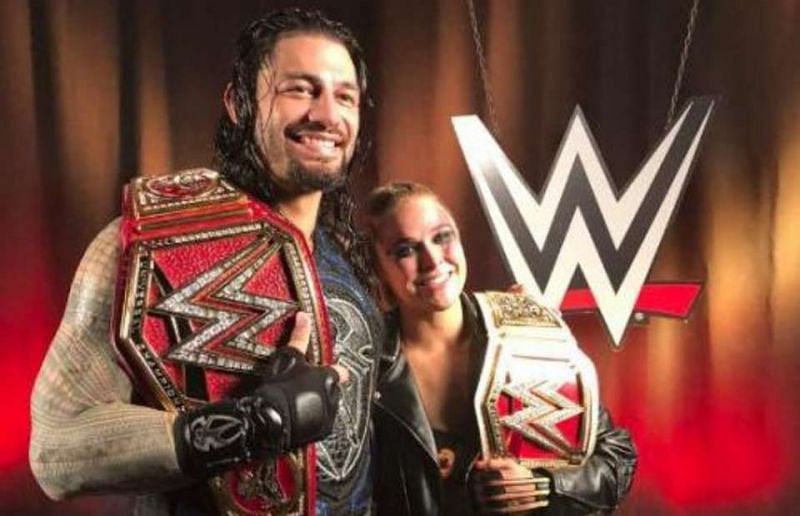 Ronda Rousey with Roman Reigns following their respective title wins at SummerSlam