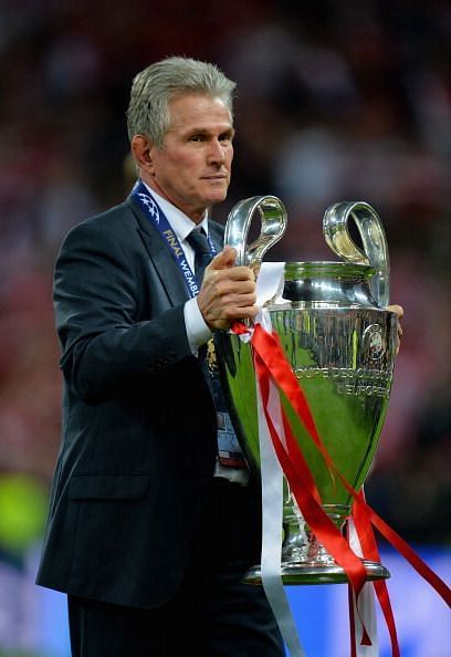 Jupp Heynckes holding the 2012-13 UEFA Champions League trophy.