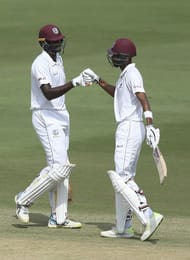 Chase and Holder congratulating each other after a century partnership