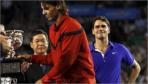 Nadal receiving the 2009 Australian Open Trophy with a tearful Federer in the backdrop