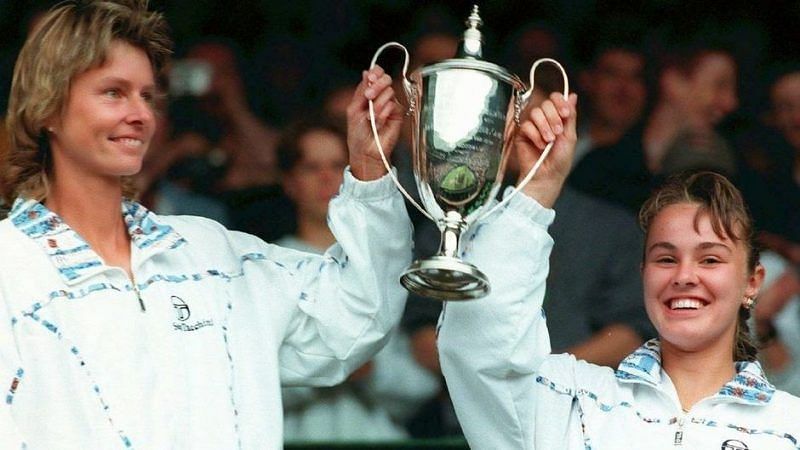 15-year old Martina Hingis and Helena Sukova lifting the 1996 Wimbledon trophy