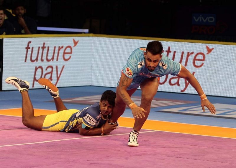 C. Arun attempting a diving ankle hold on Maninder Singh.