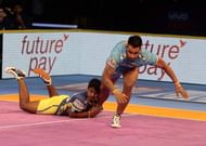 C. Arun attempting a diving ankle hold on Maninder Singh.
